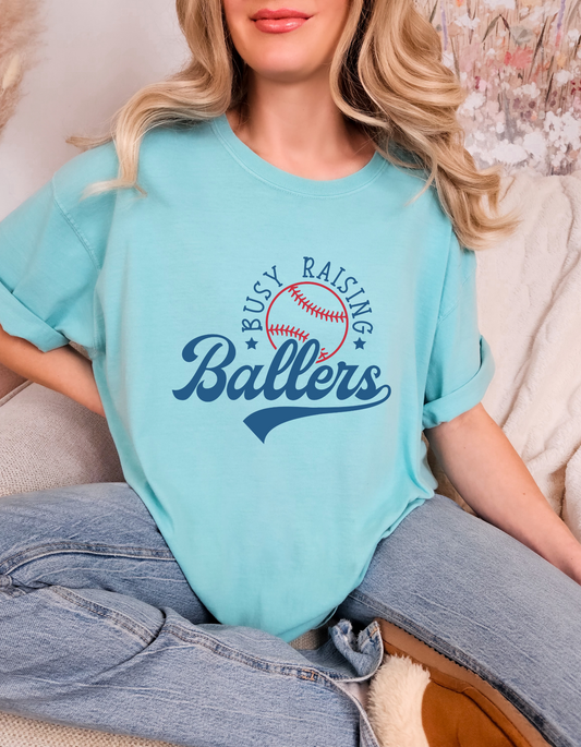 Comfort Colors® Busy Raising Ballers T-Shirt | Baseball Season Apparel | Mom Life Baseball Tee | Baseball Lifestyle Shirt