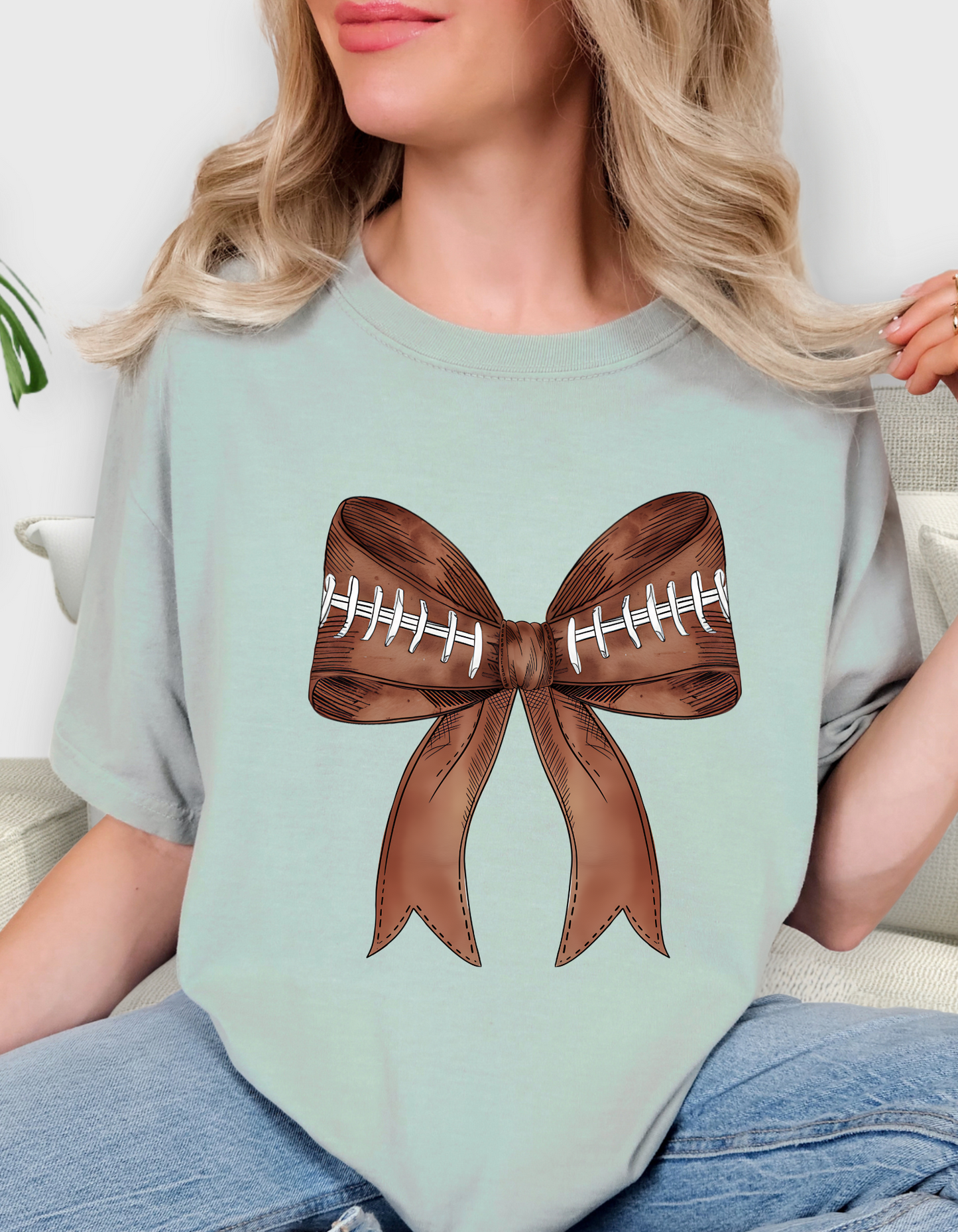 Comfort Colors® 'Football Bow' T-Shirt | Women’s Game Day Fashion | Girly Football T-Shirt | Bow and Football Graphic Tee