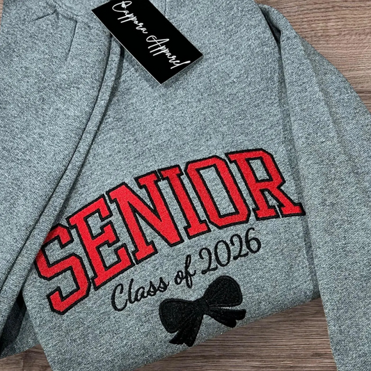 Celebrate graduation in style with our embroidered Senior Class of [Year] Gildan crewneck. Cozy fleece, custom embroidery, and perfect senior gift apparel!